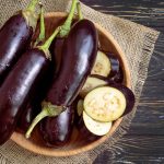 Whole eggplant on wooden background